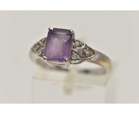 A 9CT WHITE GOLD AMETHYST AND SPINEL RING, set with a rectangular cut amethyst, four claw set, flanked with colourless spinel