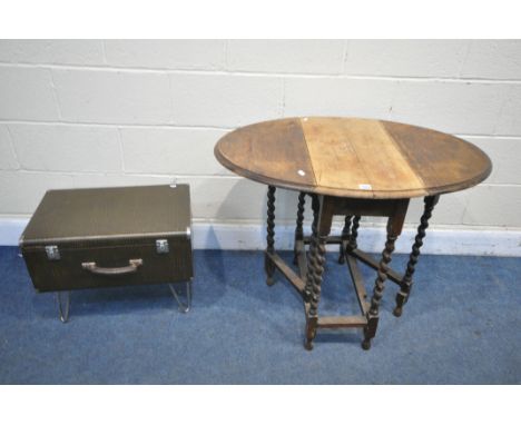 A SMALL OAK BARLEY TWIST OVAL GATE LEG TABLE, along with a sewing machine case, on hairpin legs (condition:- the centre top o