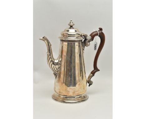 A GEORGIAN SILVER COFFEE POT, tall polished pot with engraved family crest, leaf detail to the spout base, fitted with a ligh