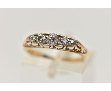 A YELLOW METAL FIVE STONE DIAMOND RING, set with five graduated old cut diamonds, each claw set in a scrolling gallery, polis