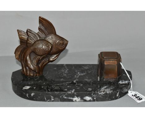 AN ART DECO INKSTAND DECORATED WITH FISH, having a dark grey marble base with pen rest, surmounted by a bronzed figure group 