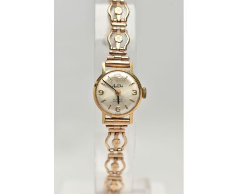 A GOLD WRISTWATCH, the circular face with baton and Arabic numerals, to the fancy link strap, with safety chain, strap with 9