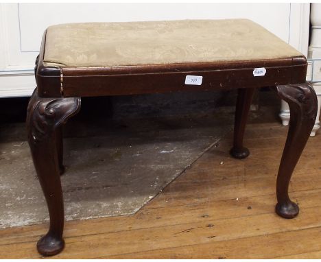 An upholstered stool, on carved cabriole legs