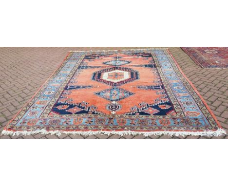 A Persian Viss carpet, with geometric motifs on a red/orange ground, 353 x 261 cm Condition report Report by NG

End threads 