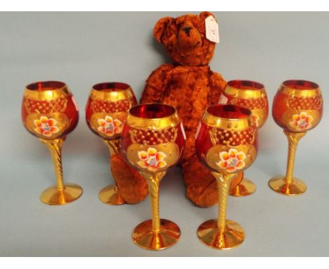 A set of six ruby hock glasses, with gilt and enamel decoration, and a plush jointed teddy bear (7)