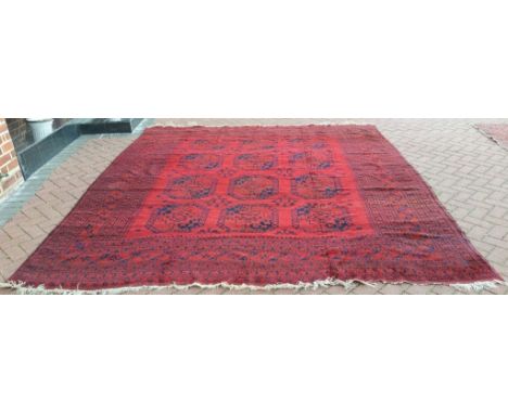 An Afghan carpet, with elephant ghul decoration on a red ground, 315 x 284 cm Condition report Report by NG

Carpet damp, wit