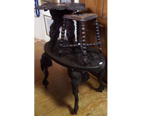 An early 20th century Indian carved wood oval table, 91 cm wide, a similar table, and a stool (3)