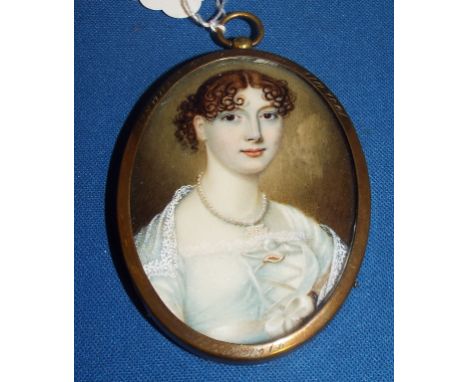 An oval bust portrait miniature, of a lady wearing pearls, 7.5 x 5.5 cm, in a later frame Condition report Report by NG

On i