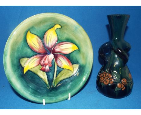 A Moorcroft pottery orchid pattern plate, Laelia Autumnalis, 19 cm diameter, and an Elton Ware pottery vase, 19 cm high (2) C