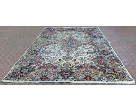 A Kashmar carpet, with central floral medallion on a white ground, 343 x 232 cm