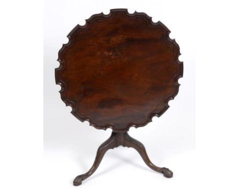 A mahogany tripod table, the pie crust top on a rope twist and vase turned column, leaf capped downswept legs and claw and ba