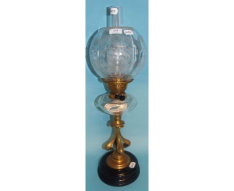 An oil lamp, with Art Nouveau style column, clear glass reservoir and etched shade, 61 cm high