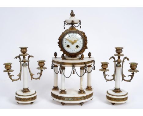 A French clock garniture, the clock having an 8.5 cm diameter enamel dial with Arabic numerals, fitted an eight day movement,