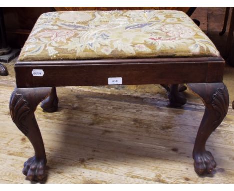An 18th century style walnut stool, with a needlework upholstered top, shell carved cabriole legs and claw and ball feet