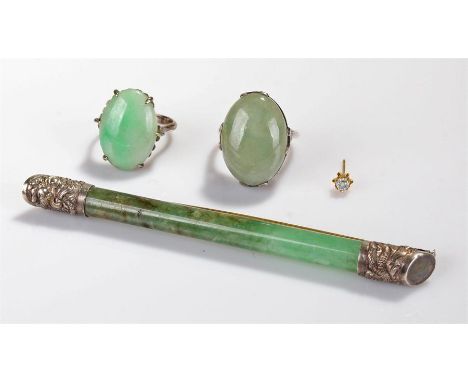 Jade jewellery, to include a long brooch with Chinese white metal mounts to the end, 9cm long, together with  and two jade ri