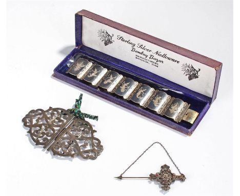 Silver nurses buckle, together with a stick pin and a Siam silver bracelet, (3)