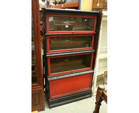 Four Section Globe-Wernicke Stacking Bookcase, with an ebonised and red finish, the top two sections with glass front, above 