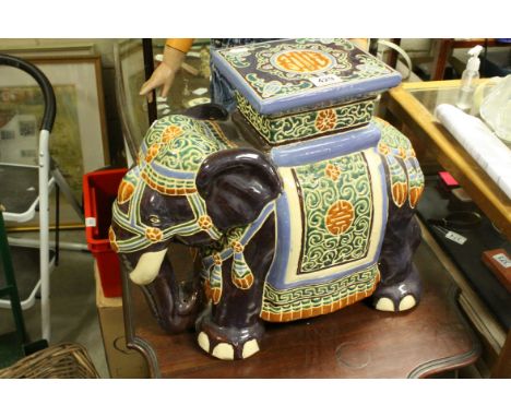 A contemporary ceramic elephant garden seat.