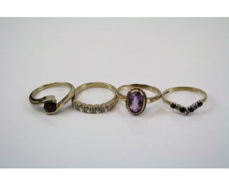 Four ladies 9ct gold and gemstone rings to include a sapphire wishbone ring.