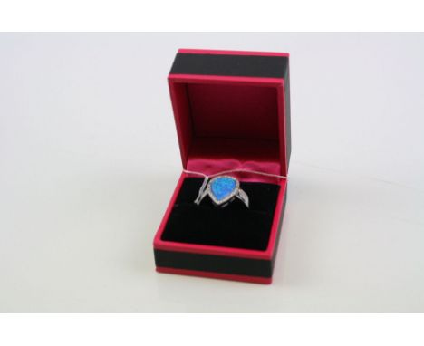 A silver CZ and blue opal teardrop shaped ring.