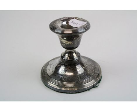 A fully hallmarked sterling silver candlestick with a Birmingham assay mark.