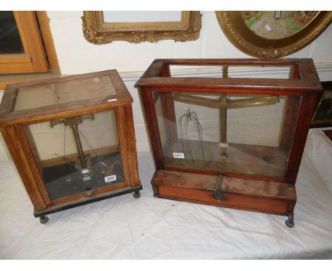 Wooden and Glass Cased Set of Chemist's Scales, 43cms high together with two similar sets (one foot missing to the case)