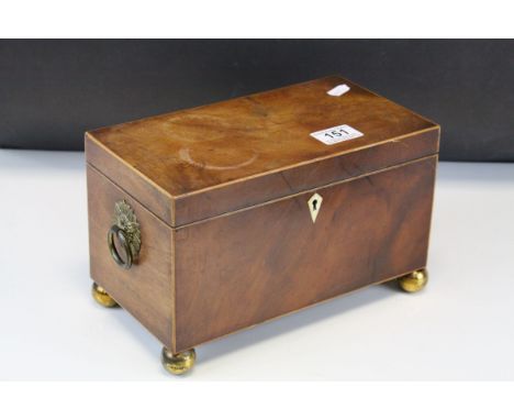 Regency Mahogany Tea Caddy, the hinged lid opening to reveal two covered tea compartments, raised on four brass ball feet, 16