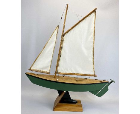 SCALE MODEL SAILING BOAT - of wooden construction, the hull painted green, the keel black, fully rigged with a stand, 71cms H