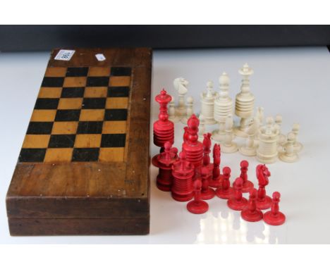 A antique caved bone red &amp; white chess set in wooden box. 