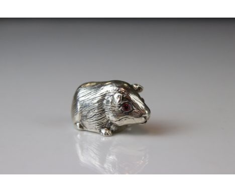 Silver figure of a guinea pig with ruby eyes 