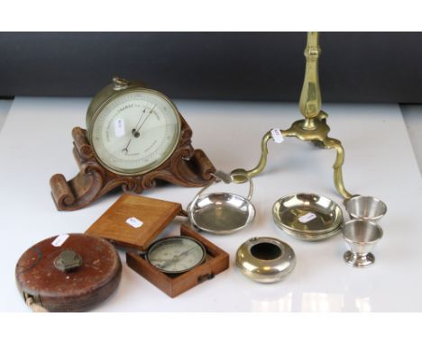 A box of mixed collectables to include a barometer, tape measure and a brass candlestick. 