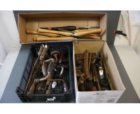 A collection of vintage tools to include planes, chisels and hand drills. 