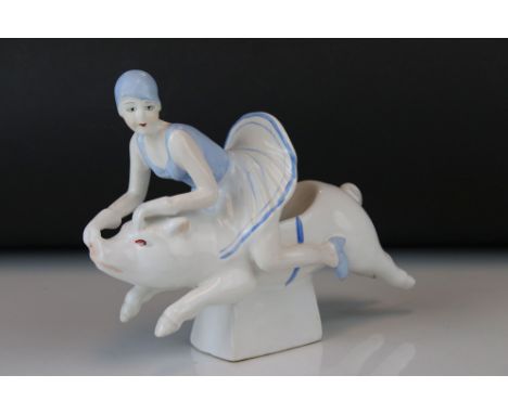 Ceramic figure of a lady riding a pig 
