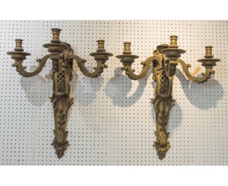 WALL LIGHTS, a pair, 19th century French gilt bronze three branch, each with a shell surmount and leaf decoration, 56cm H. (2