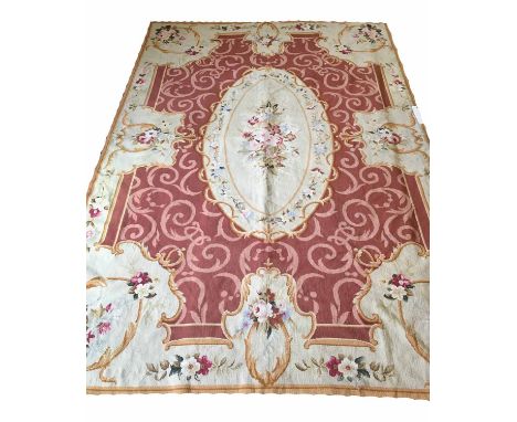 NEEDLEPOINT CARPET, Aubusson style, 270cm x 175cm, of floral spray in oval reserve on coral field within scrolling acanthus b