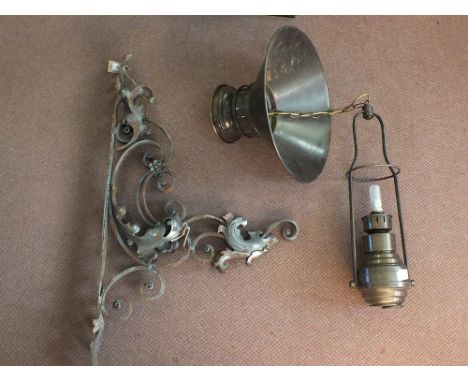 A Wrought Iron bracket with dragons head and a hanging lamp