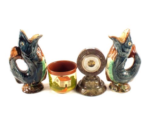 A Serpentine barometer, Devon ware plant pot plus a pair of Majolica fish jugs (one as found)