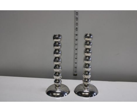 A pair of plated bobbin style candlesticks 