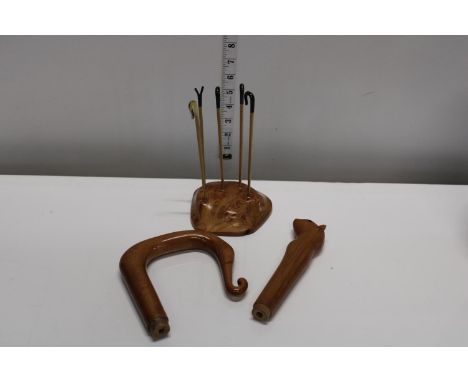A good selection of treen items, walking stick handles etc 