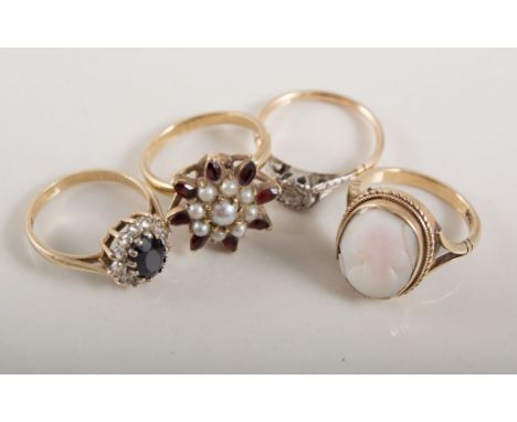 Four yellow metal dress rings, an illusion set diamond solitaire, approximately 0.08carat, a garnet and pearl cluster, a came