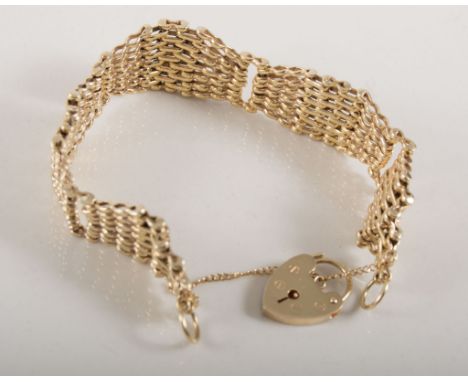 9 carat yellow gold seven bar gate link bracelet, tapered sections graduating from 15mm to 20mm wide, fitted with a padlock f
