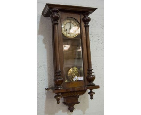 Vienna type stained beechwood wall clock, circular dial with Roman numerals, height 73cms.
