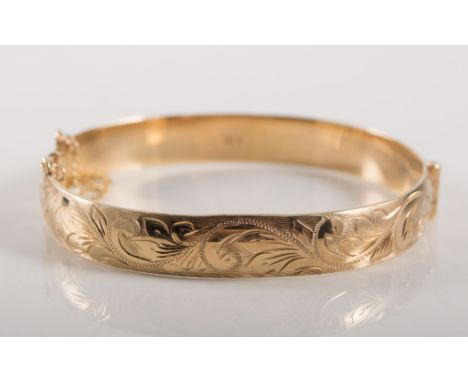 9 carat yellow gold solid half hinged bangle, 9.5cm wide, scroll engraved pattern to front, hallmarked Birmingham 1989, appro
