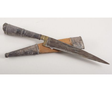 Eastern dagger, 17cms blade, white metal covered grip, in a sheath.