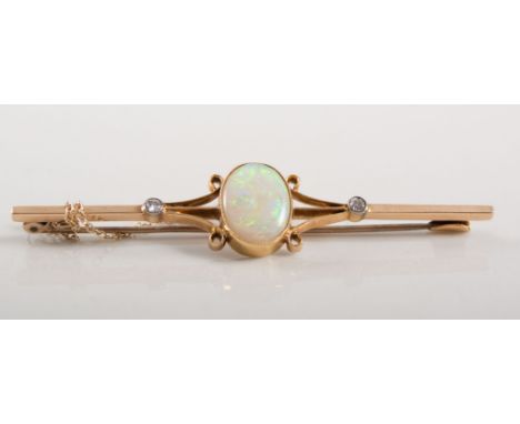 Opal bar brooch, oval cabochon cut opal 12mm x 10mm, collet set to centre of a 67mm long bar mount with scroll supports and a