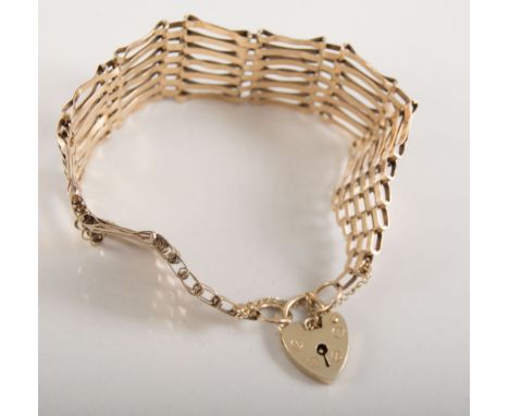 9 carat yellow gold seven bar gate link bracelet, 22mm wide, fitted with a padlock fastener hallmarked London 1976, approxima