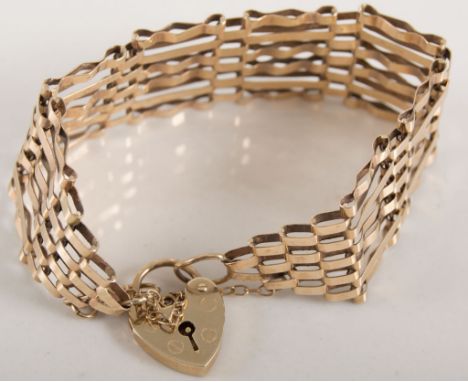 9 carat yellow gold six bar gate link bracelet 20mm wide with padlock fastener and safety chain, London 1974, approximate wei