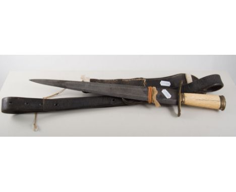 Hunting knife, carved ivory grip with brass pommel and guard,35cm steel blade with traces of decoration, mounted on a leather