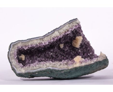 Large concave amethyst geode specimen, 50cm x 30cm, having other white quartz crystals, all displaying the trigonal symmetry.