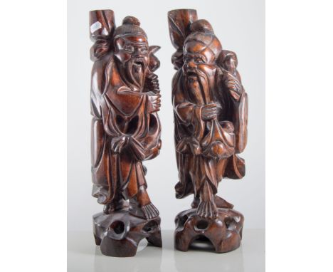 Pair of Chinese carved hardwood figural lamp bases, 20th Century, height 42cms.